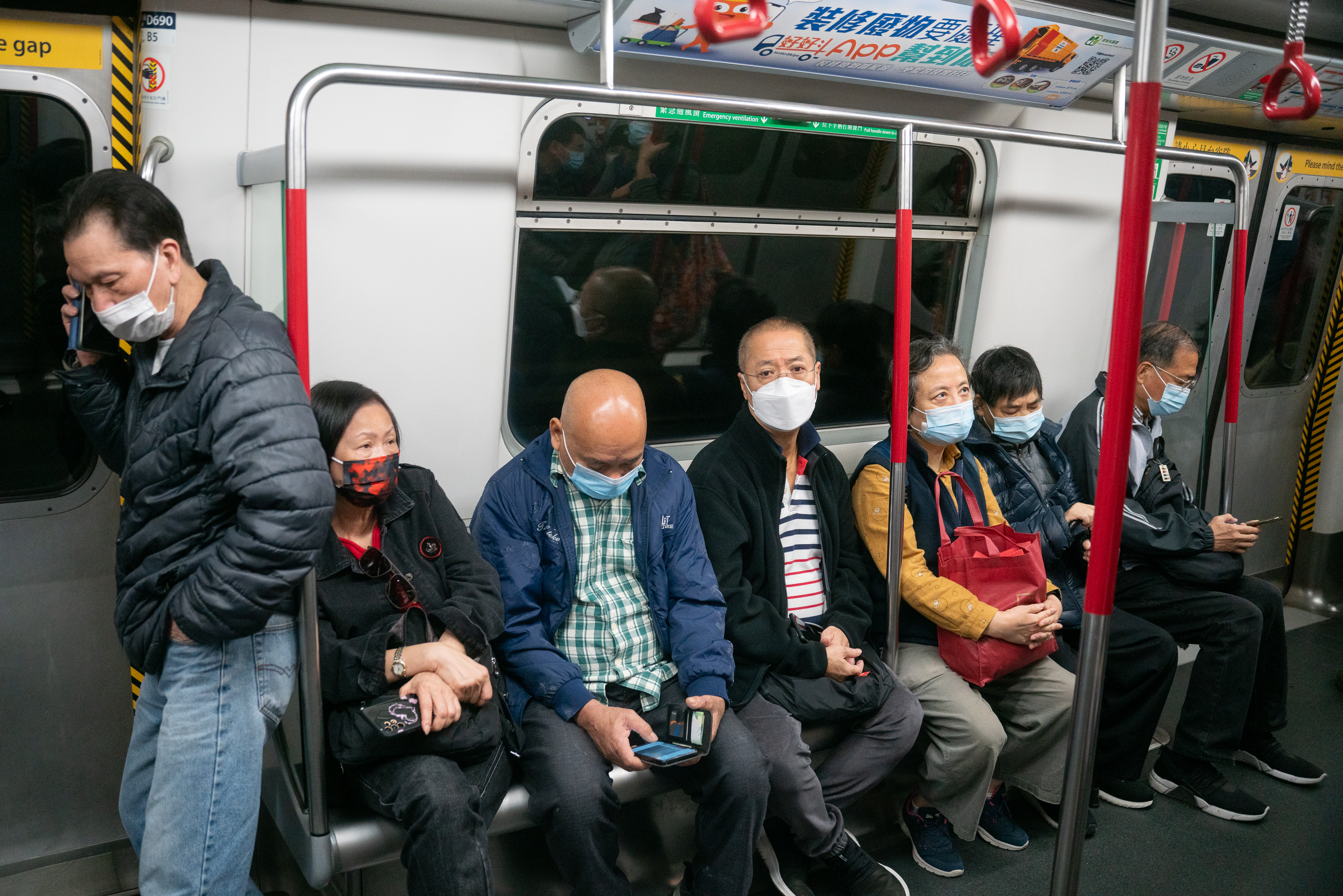 People on MTR train with mask on. (Photo Credit: Matthew Cheng)
