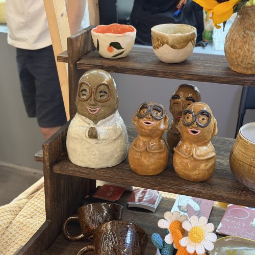 A close-up of three hand-pinched ceramic figures resembling monks on display at a booth in Central Market, Hong Kong, on April 10, 2026. Photo by Chen Meiyi.
